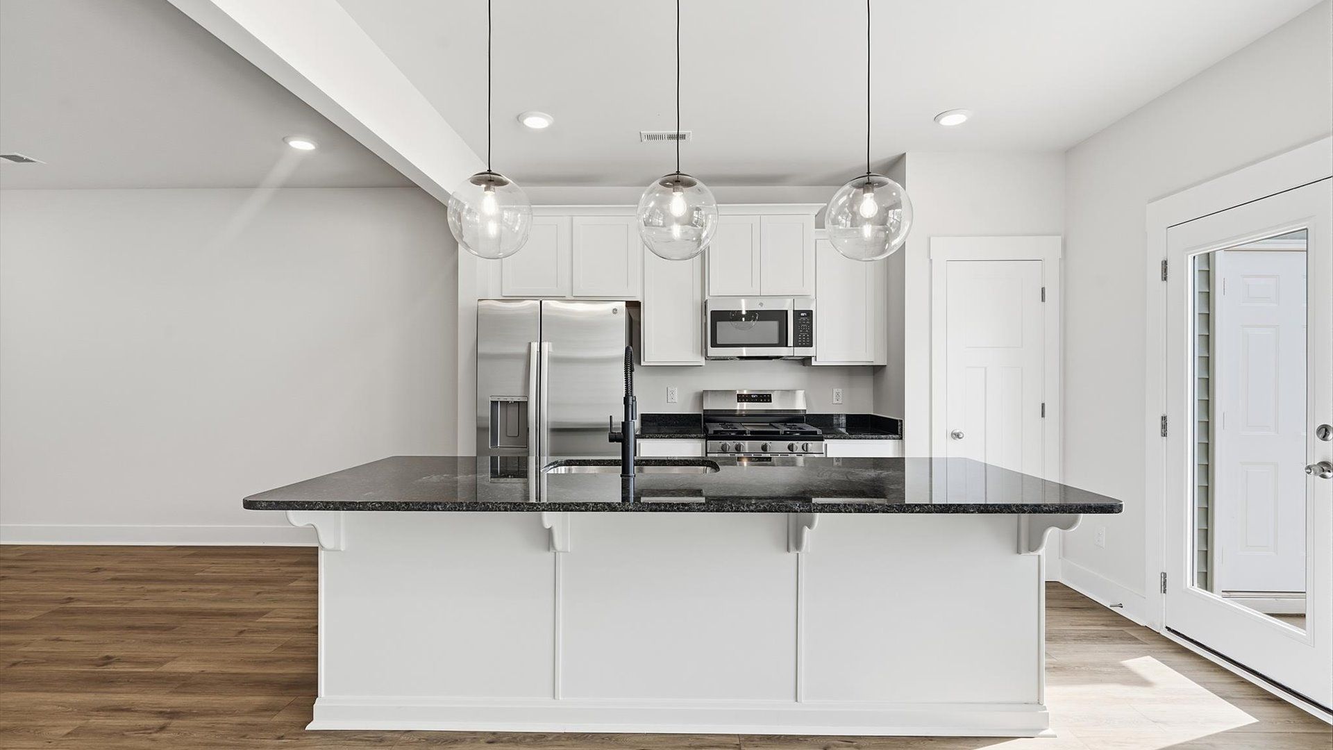 Tasteful kitchen with a streamlined island and modern finishes in a first-class DRB Homes design