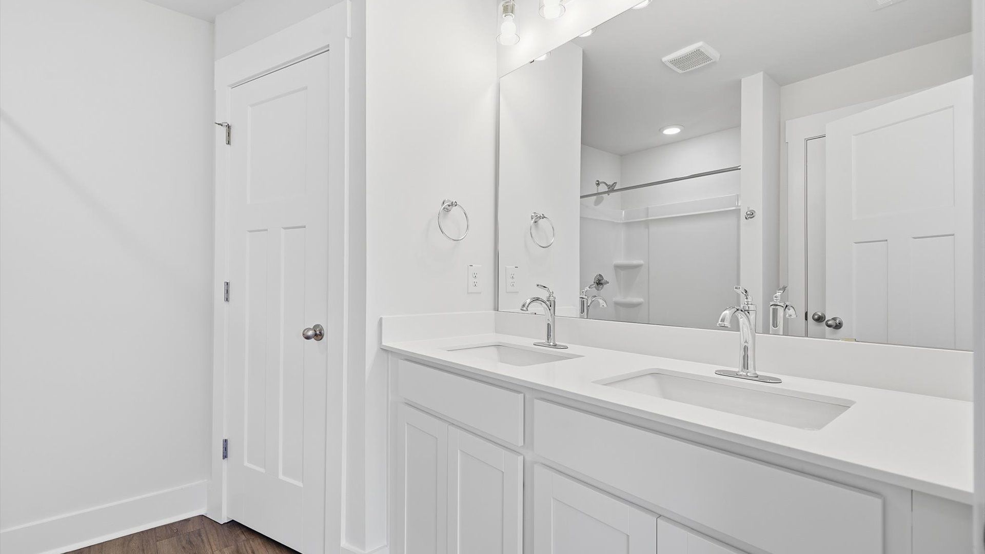 Notable primary suite with dual vanities and walk-in shower in this prime Greenville villa