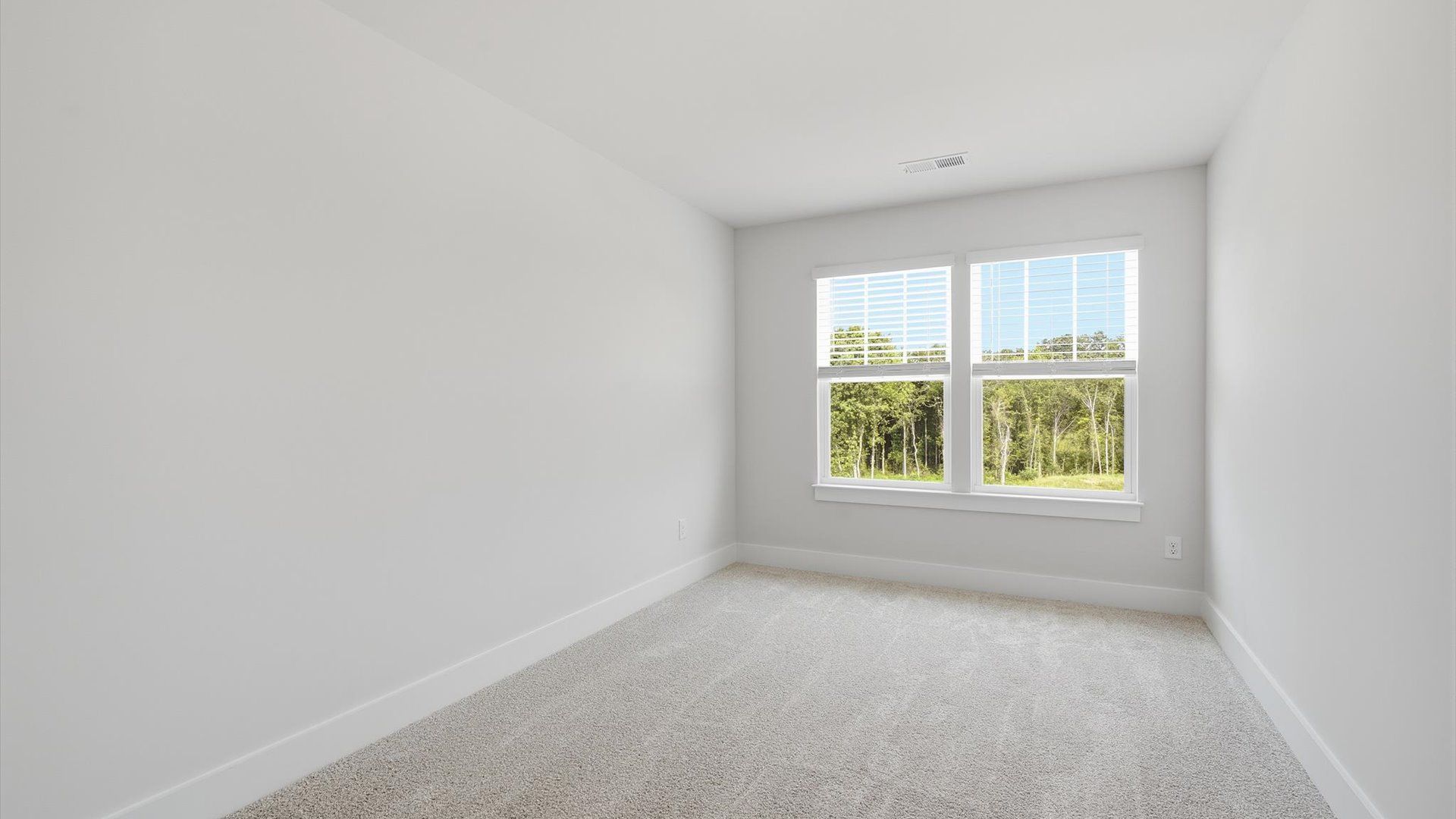 Highly functional bedroom with large windows, carpeted flooring, and tasteful finishes throughout at Marion Square