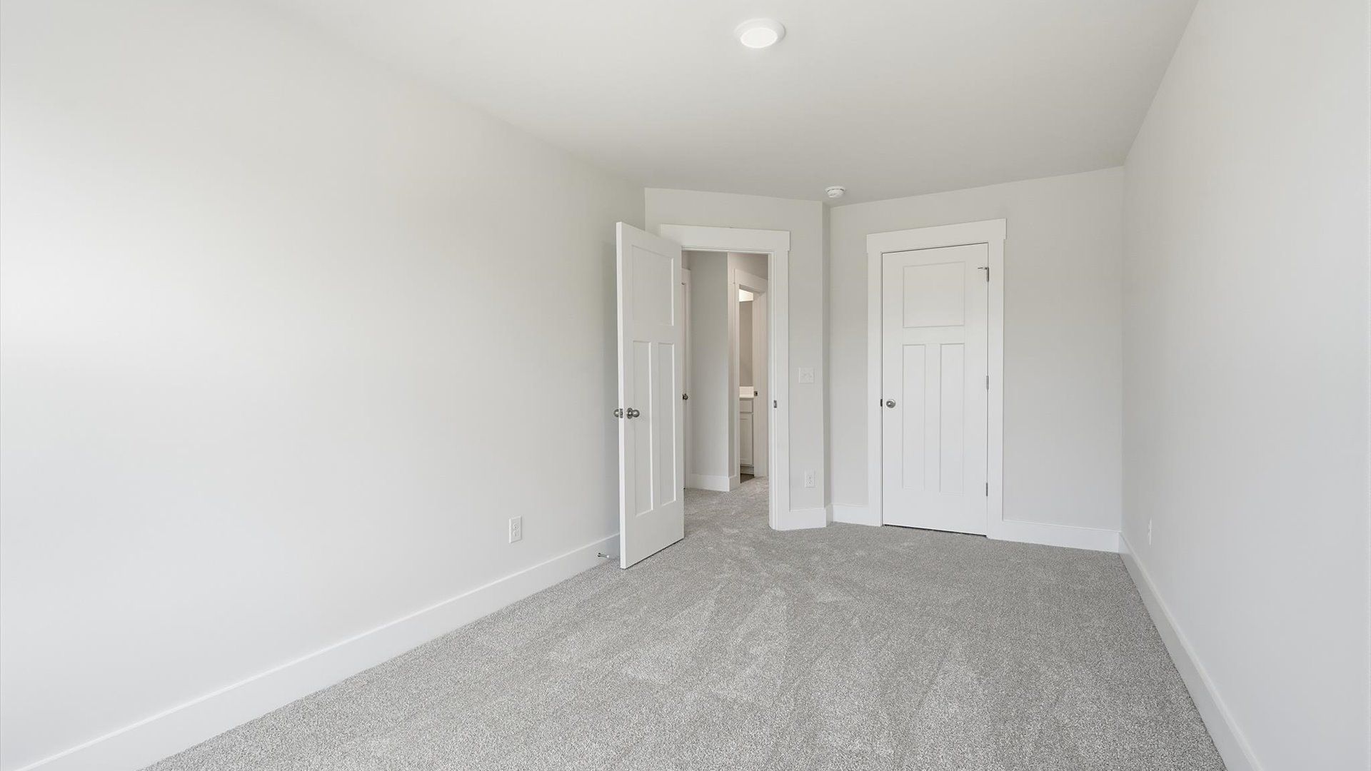 First-class secondary bedroom with comfortable carpeted flooring and generous closet space in Greenville, SC
