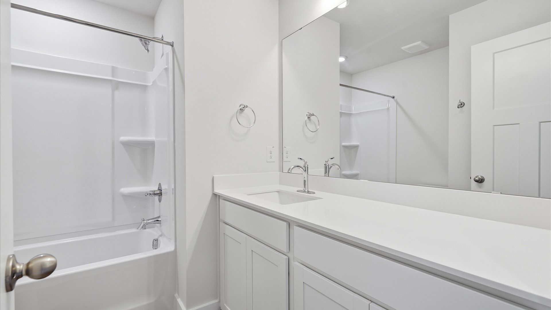 Vibrant and welcoming bathroom with elegant countertop space and polished details by DRB Homes