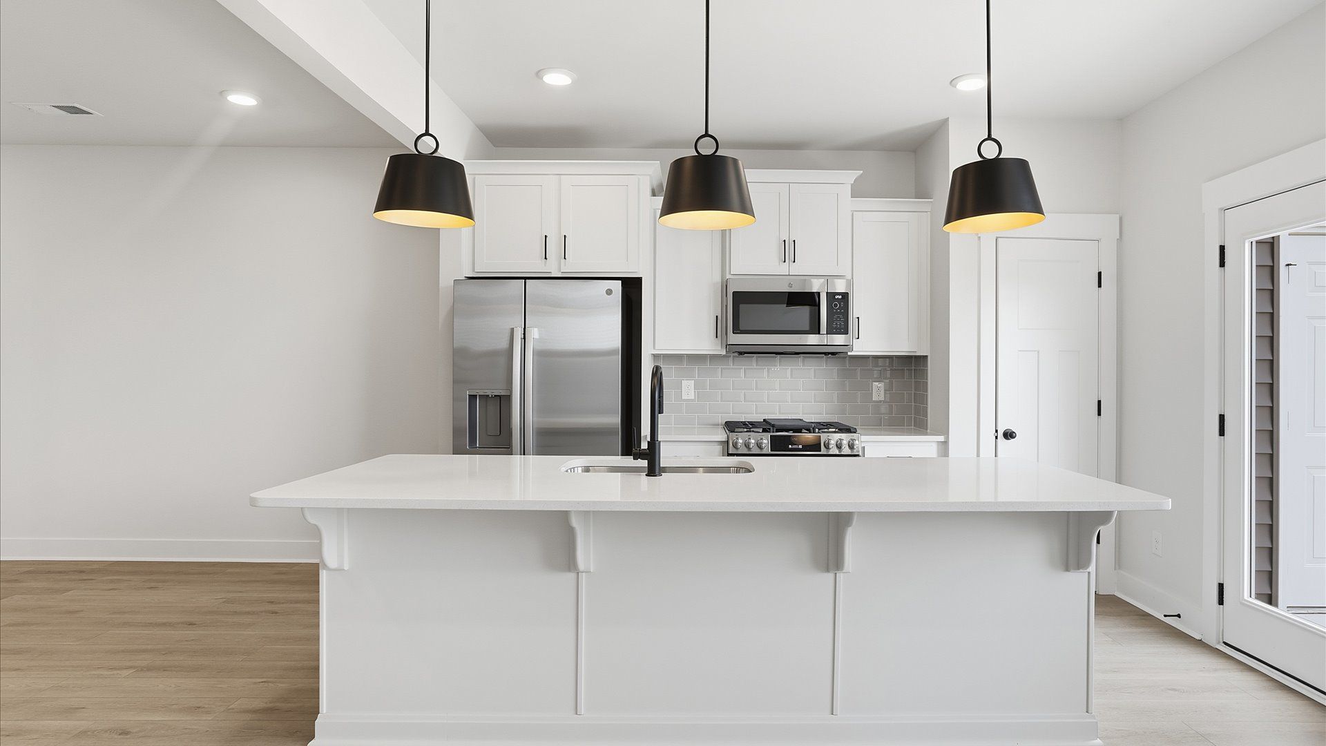 Notable 9-foot island provides generous prep and gathering space in this thoughtfully designed kitchen