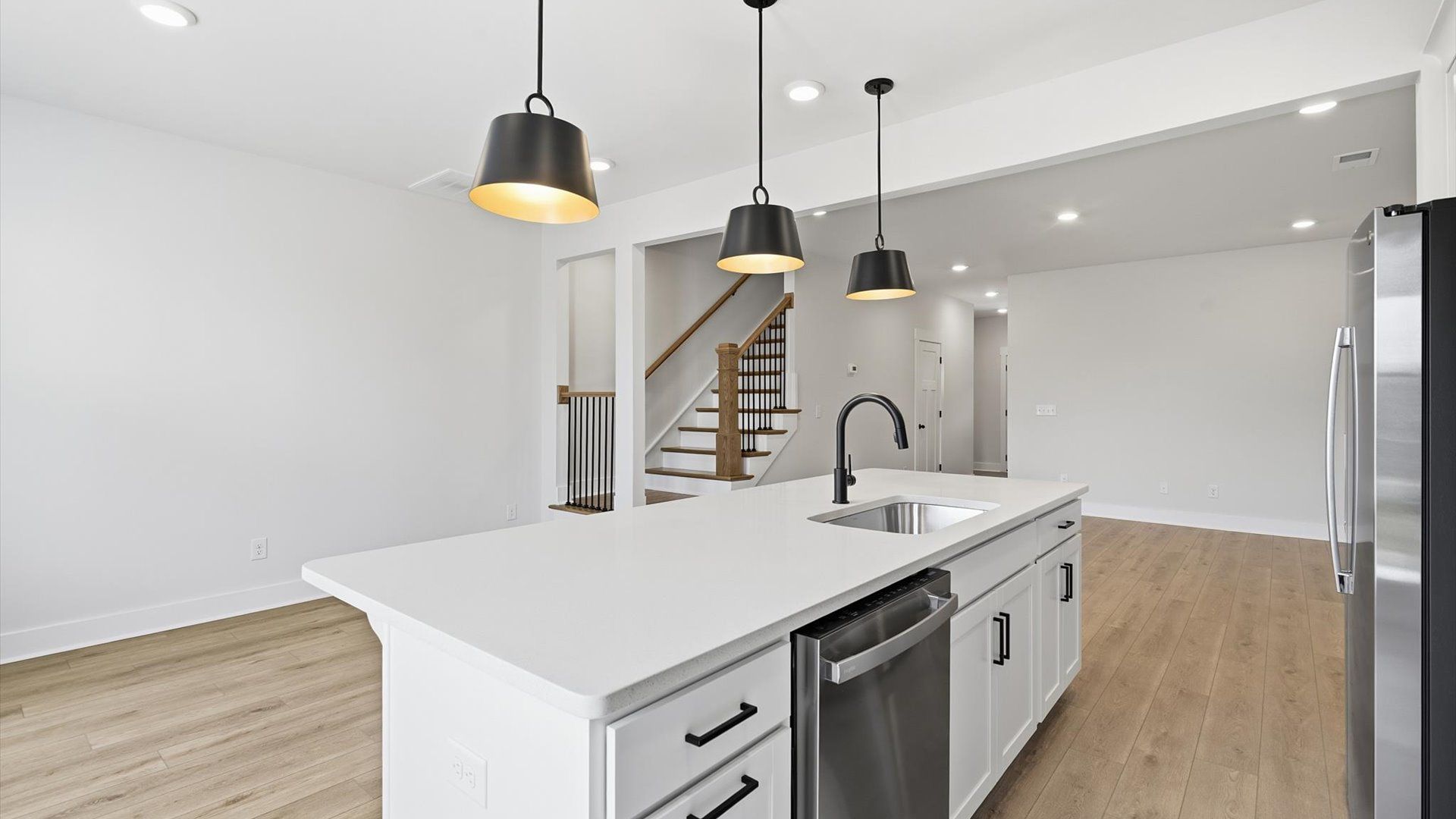 Elegant kitchen featuring a 9-foot island with pendant lighting and tasteful finishes throughout