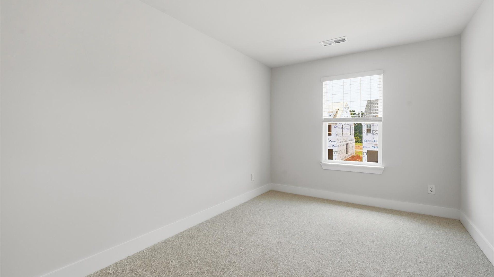 Superior comfort in a secondary bedroom with plush carpet and an oversized walk-in closet