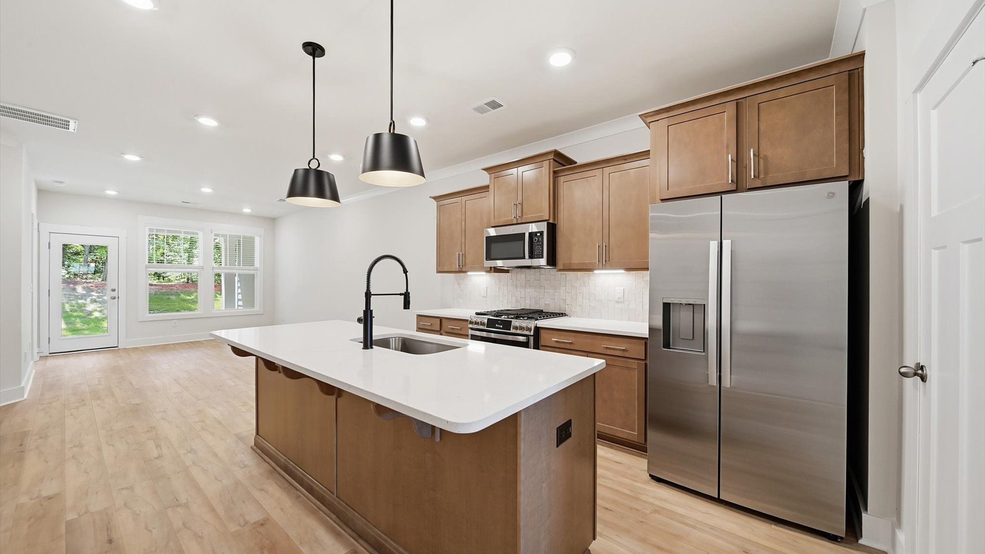 Elegant kitchen featuring a functional island and clean, current styling throughout