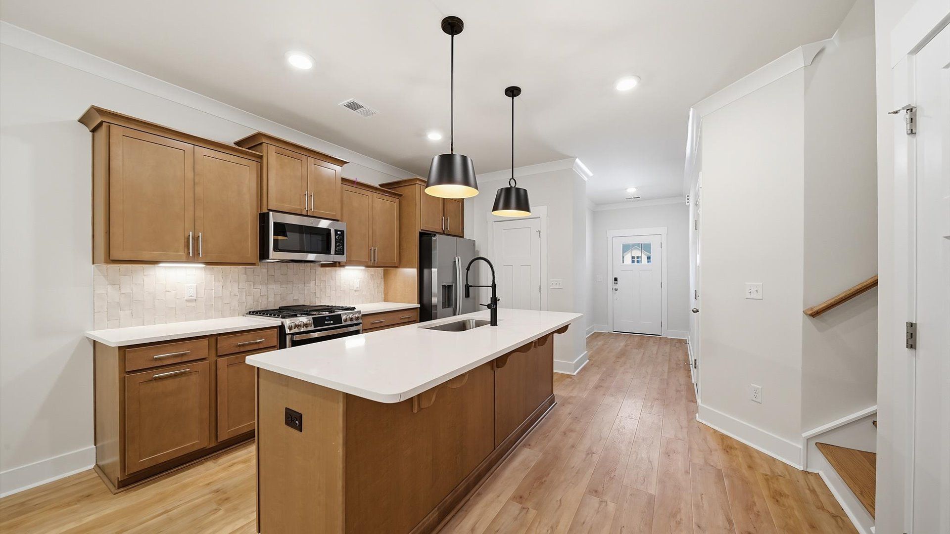 Notable kitchen space with elegant pendant lighting and a large island perfect for entertaining