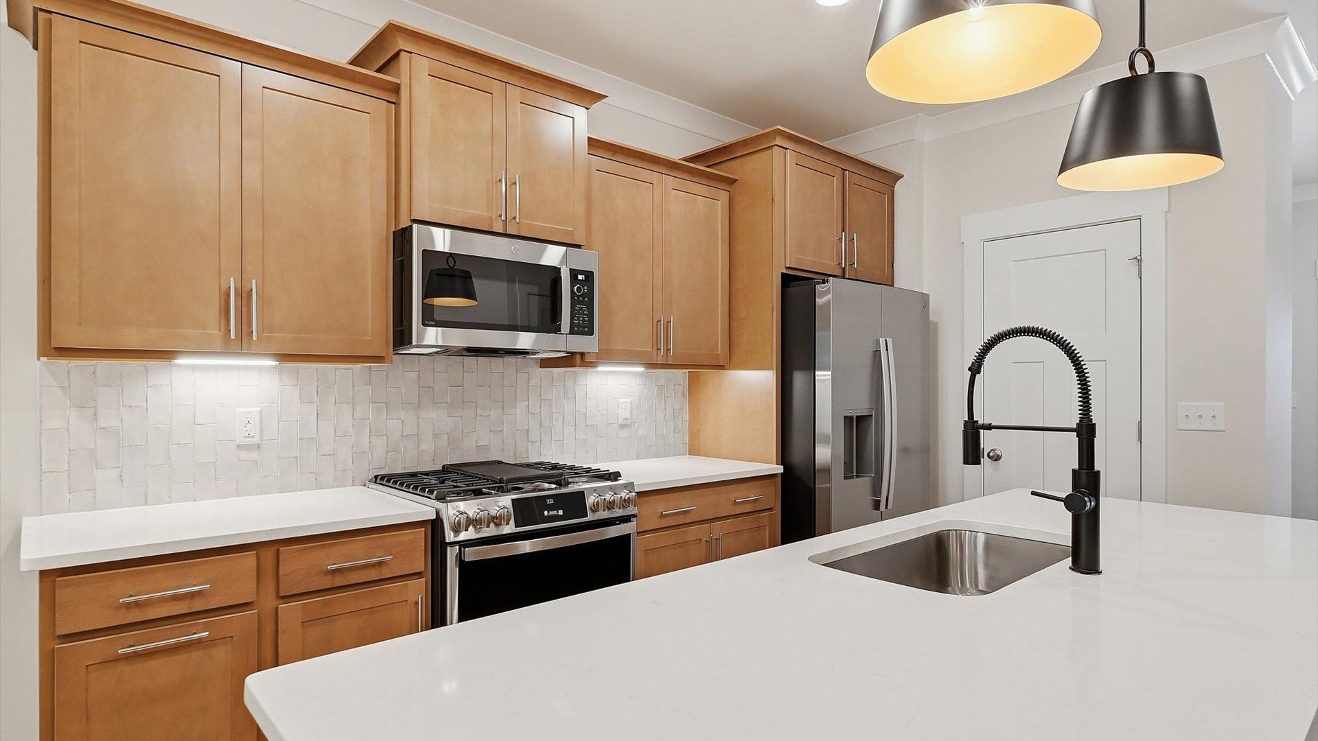 Vibrant kitchen layout with a center island, refined finishes, and open-concept flow