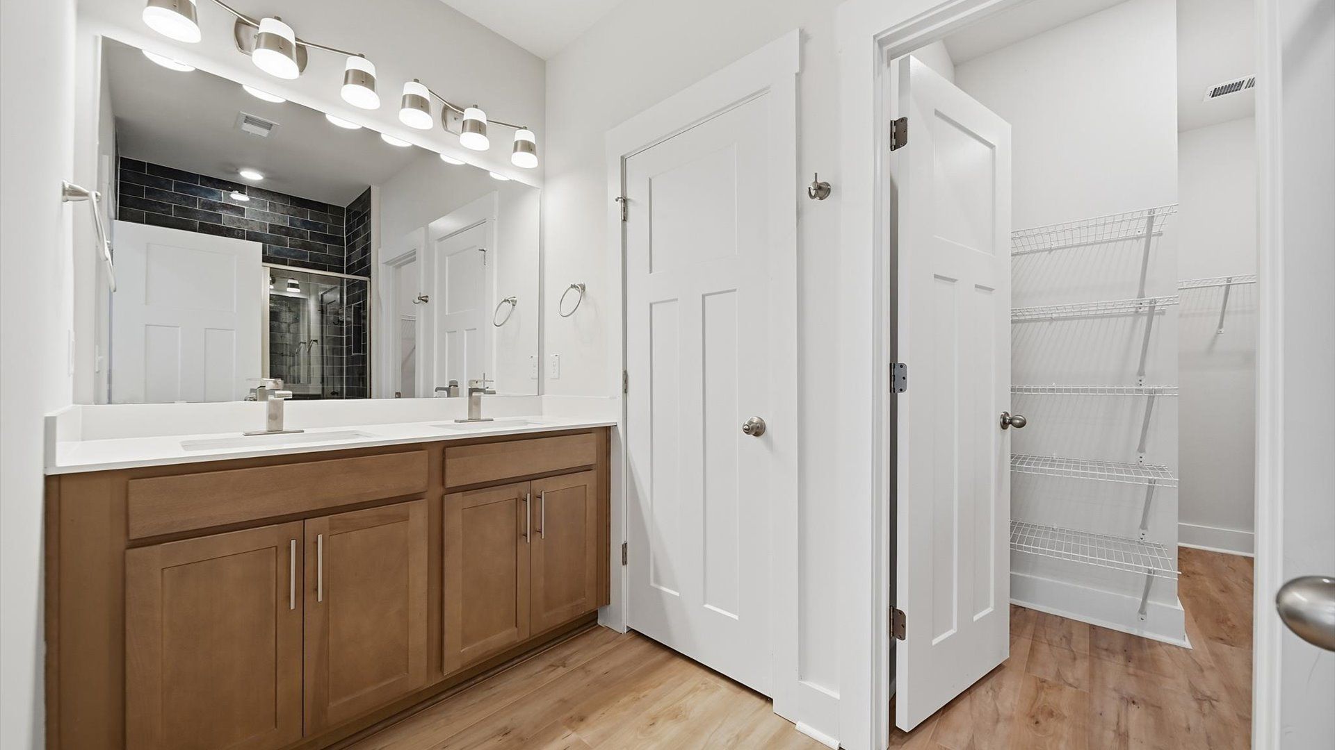 First-rate primary bathroom offering an elegant walk-in shower and dual sinks with superior style