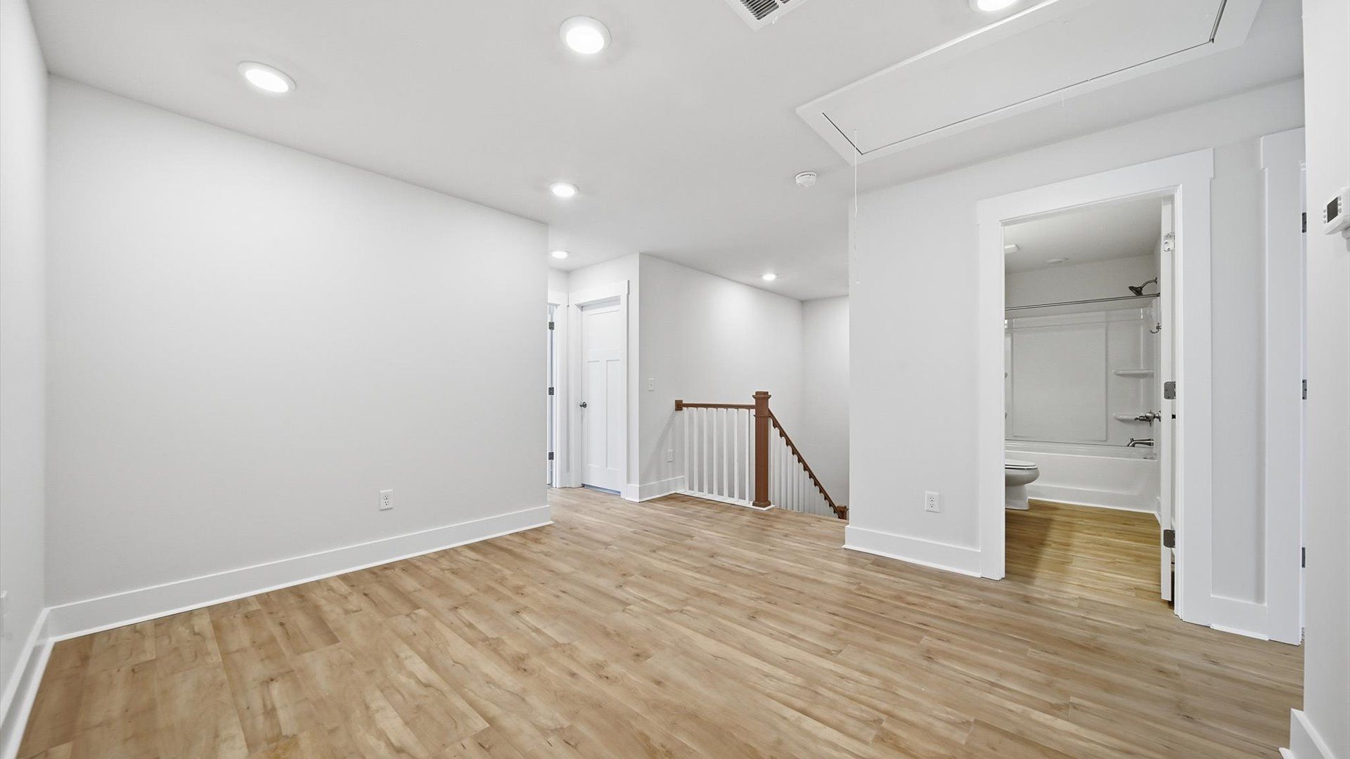 Modern loft with hardwood flooring and an open feel that enhances everyday living