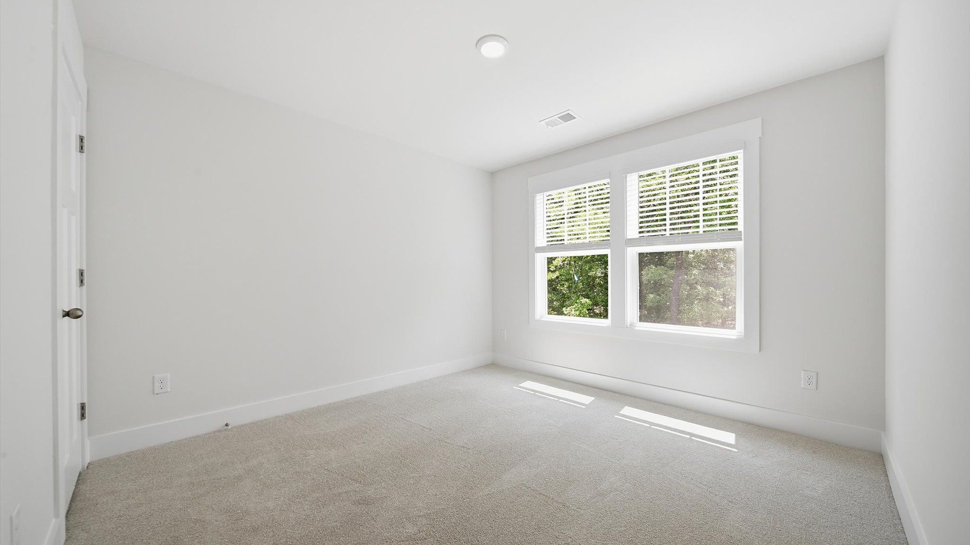 Accomplished design shines in this carpeted bedroom with a functional walk-in closet