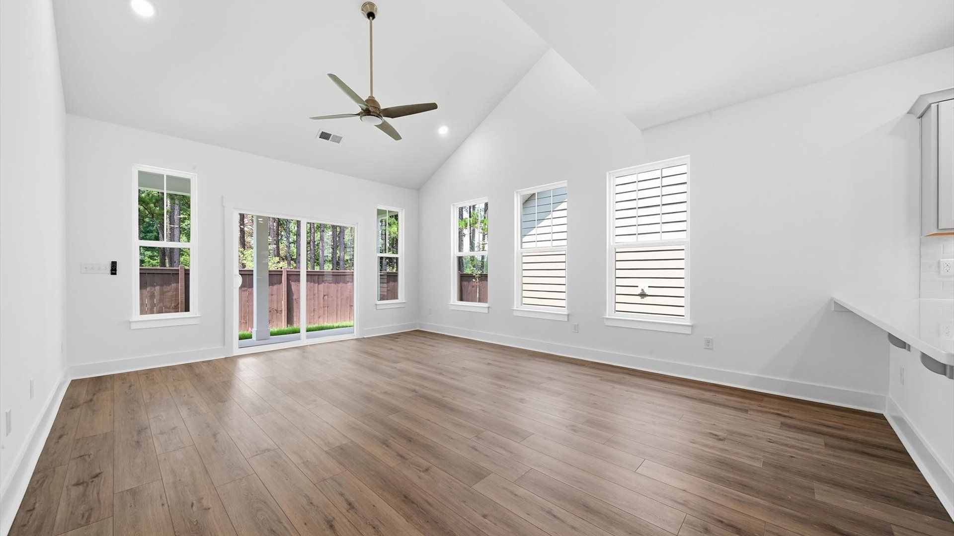 Tasteful family room with two-story volume, refined finishes, and exceptional natural light