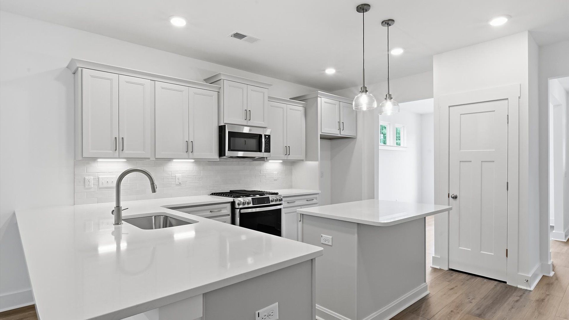 Vibrant kitchen layout with a center island, refined finishes, and open-concept flow