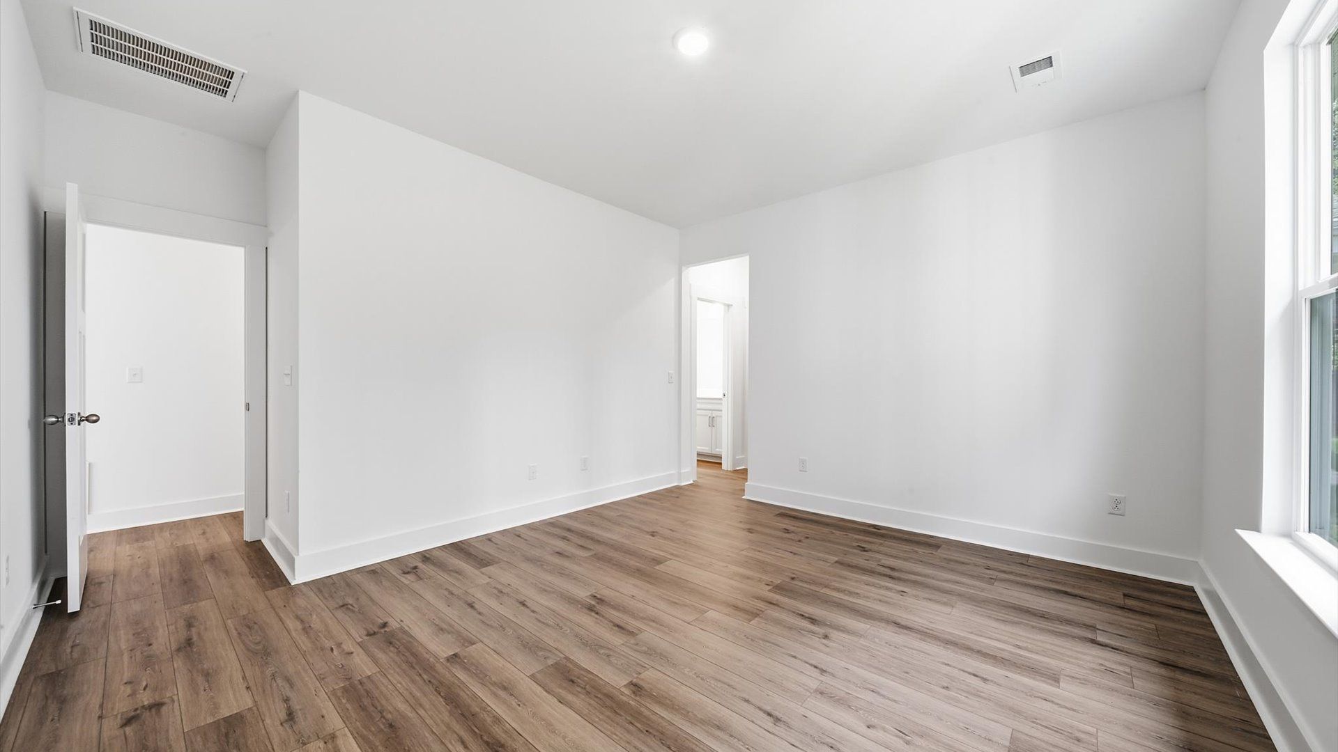 Eye-catching details and elegant finishes in the vibrant primary suite of this select home