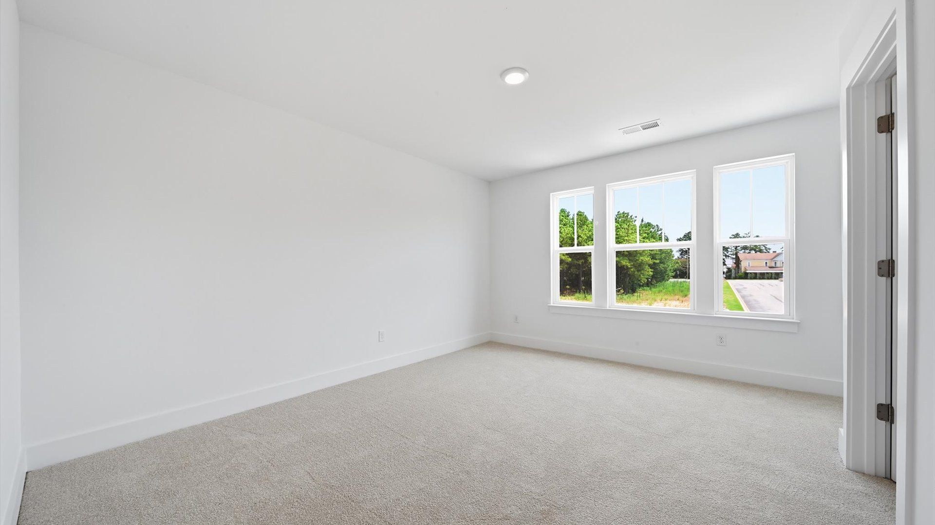 First-rate secondary bedroom with a spacious walk-in closet and elegant carpeted flooring