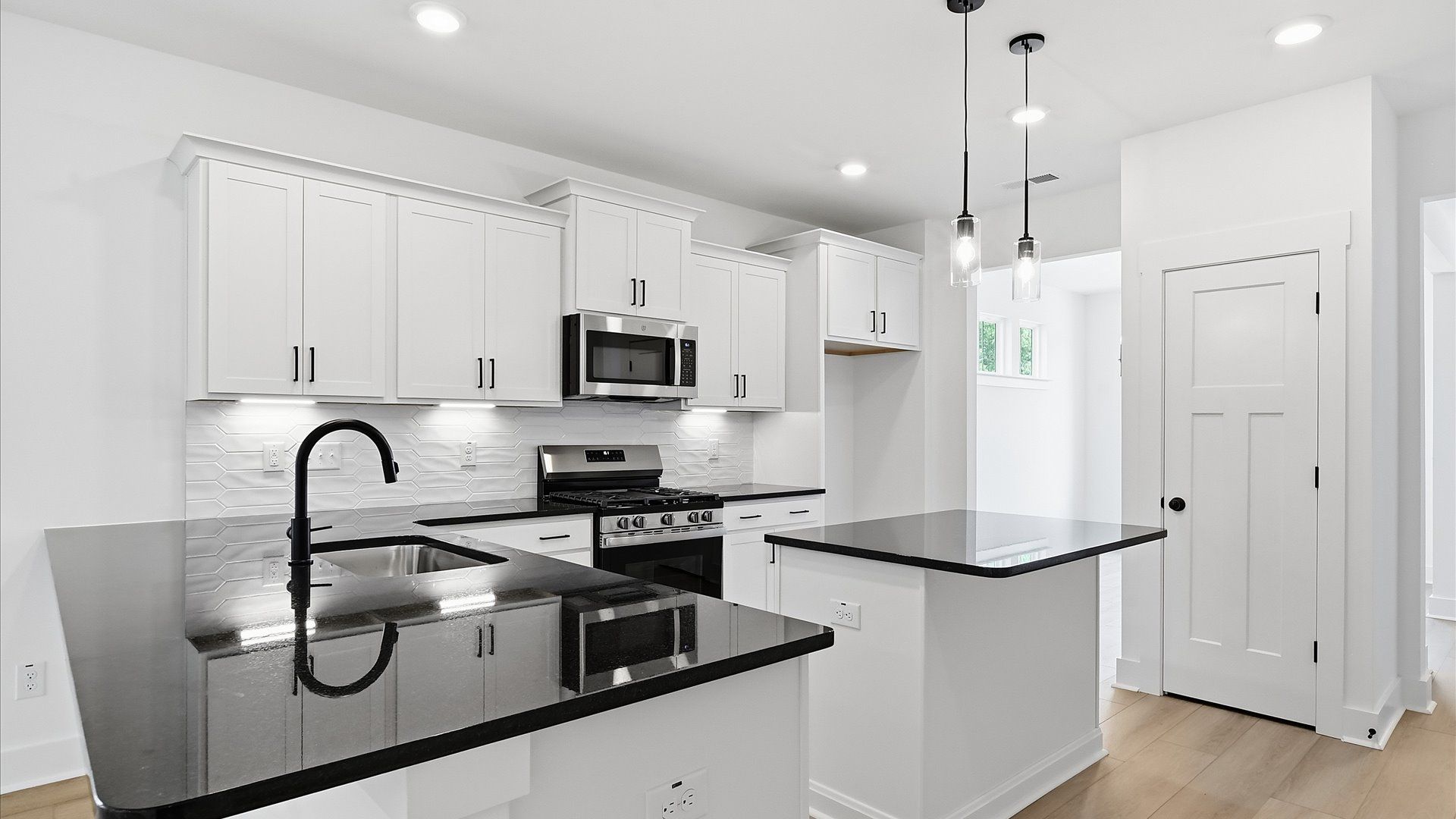 Elegant kitchen featuring a functional island and clean, current styling throughout