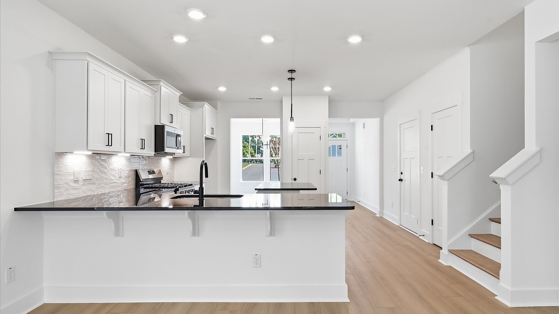 Elegant and compact island anchors this tasteful kitchen with high standards and timeless appeal