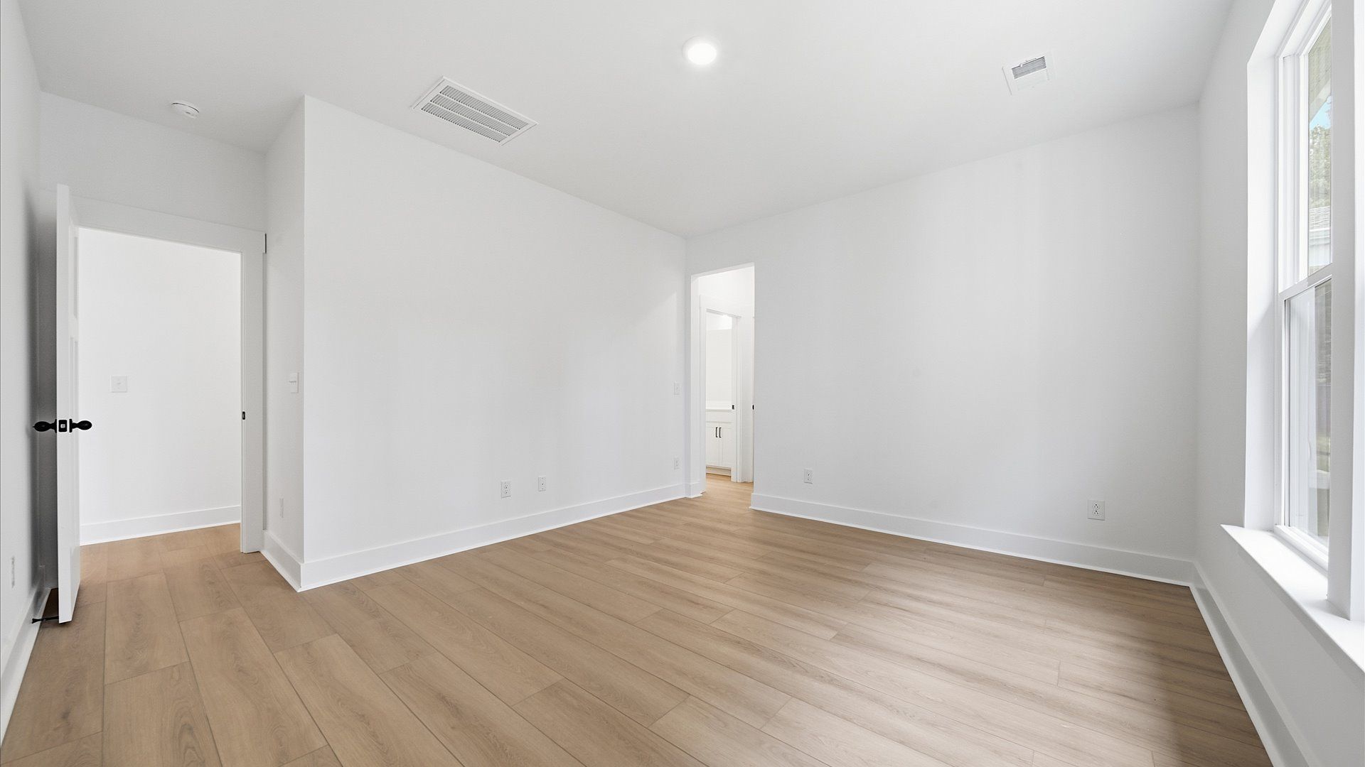 Eye-catching details and elegant finishes in the vibrant main level primary suite of this select home