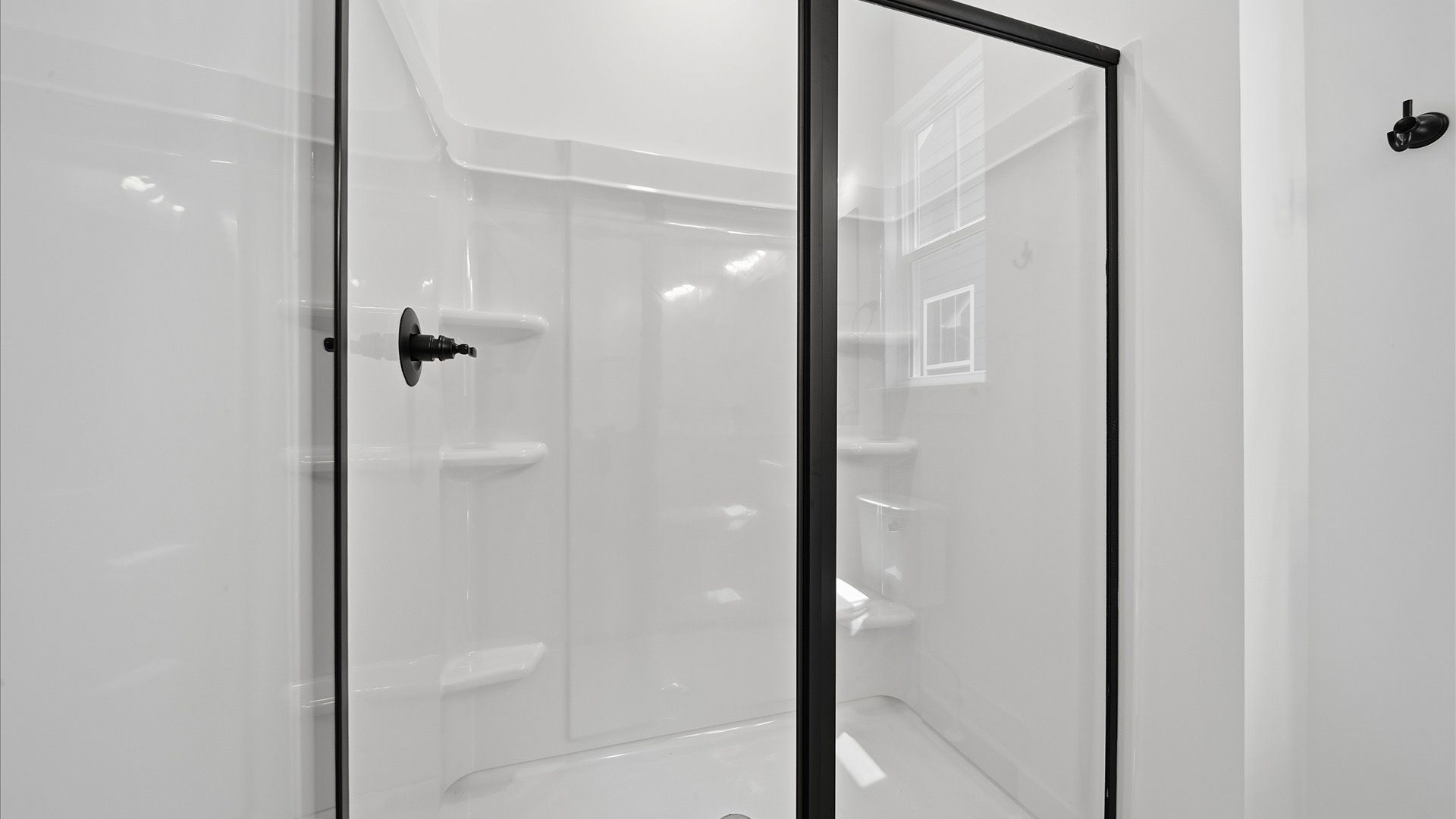Highly functional and elegant en-suite with dual vanities, walk-in shower, and refined finishes