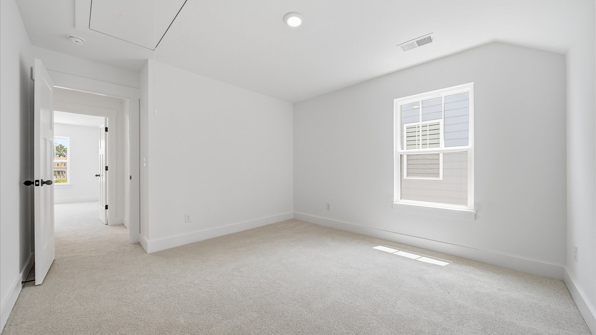 Vibrant and inviting secondary bedroom featuring a walk-in closet and refined finishes
