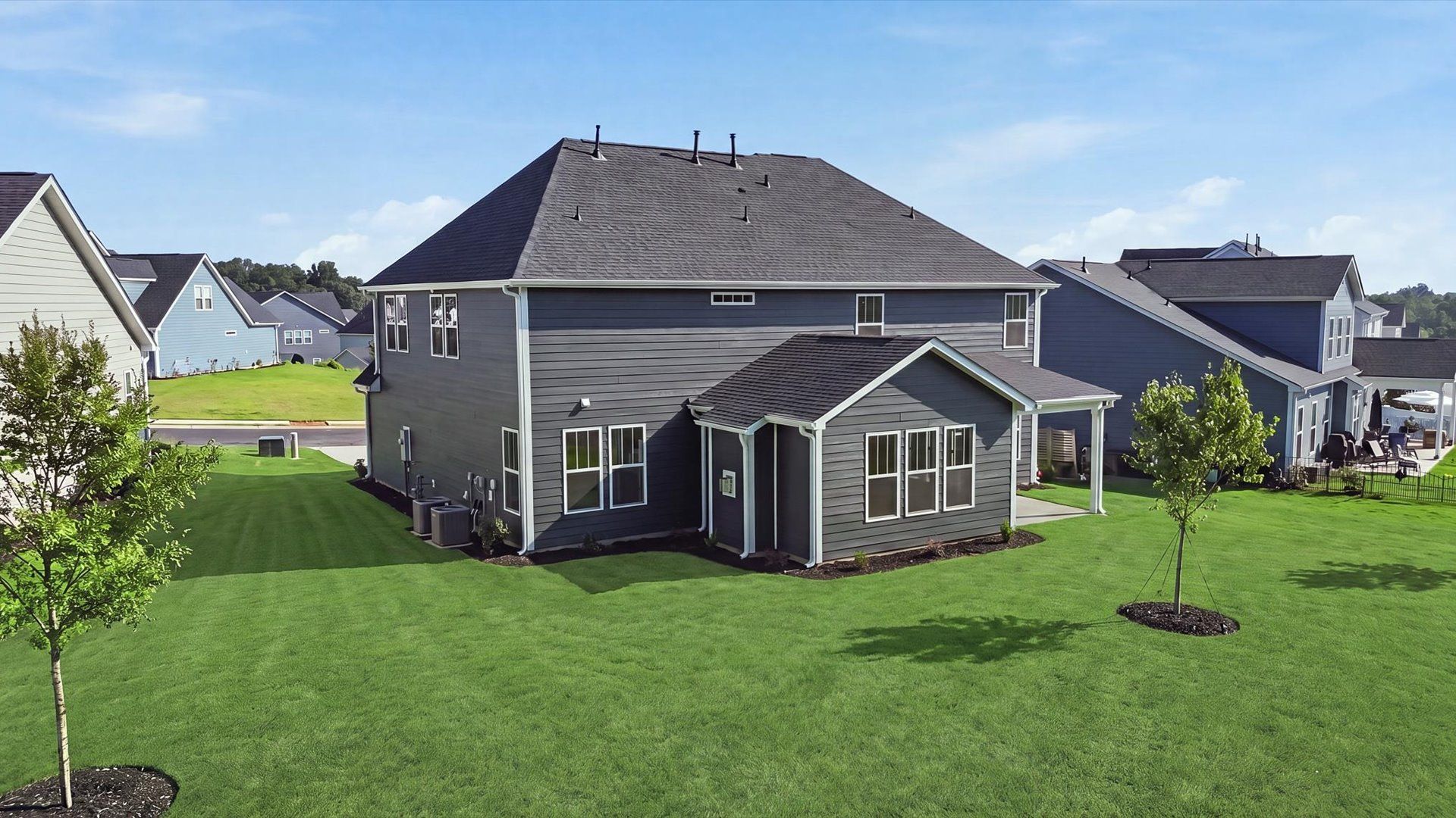 Highly functional rear covered porch adds memorable living space to this elegant home
