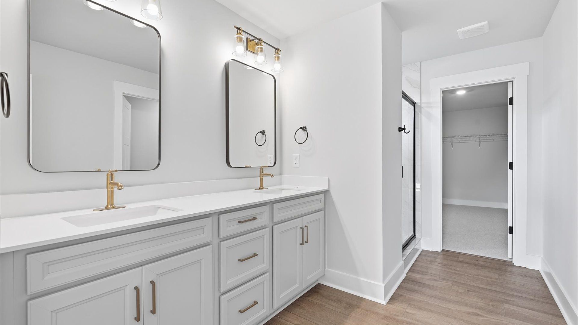 Exceptional en-suite with dual vanity and glass-enclosed tiled walk-in shower for superior everyday comfort