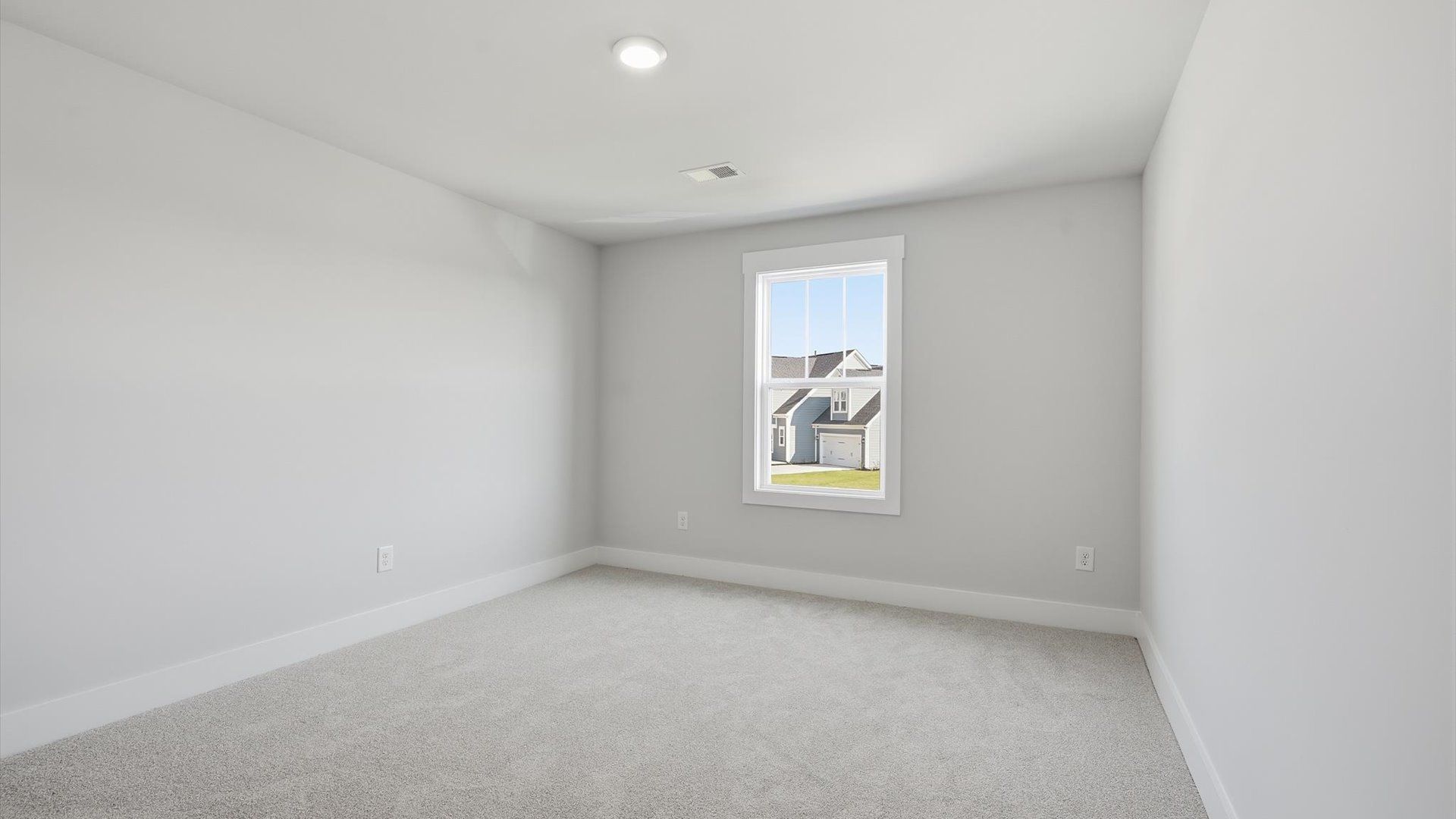 Notable secondary bedroom offering cozy carpeted flooring and a stylish walk-in closet