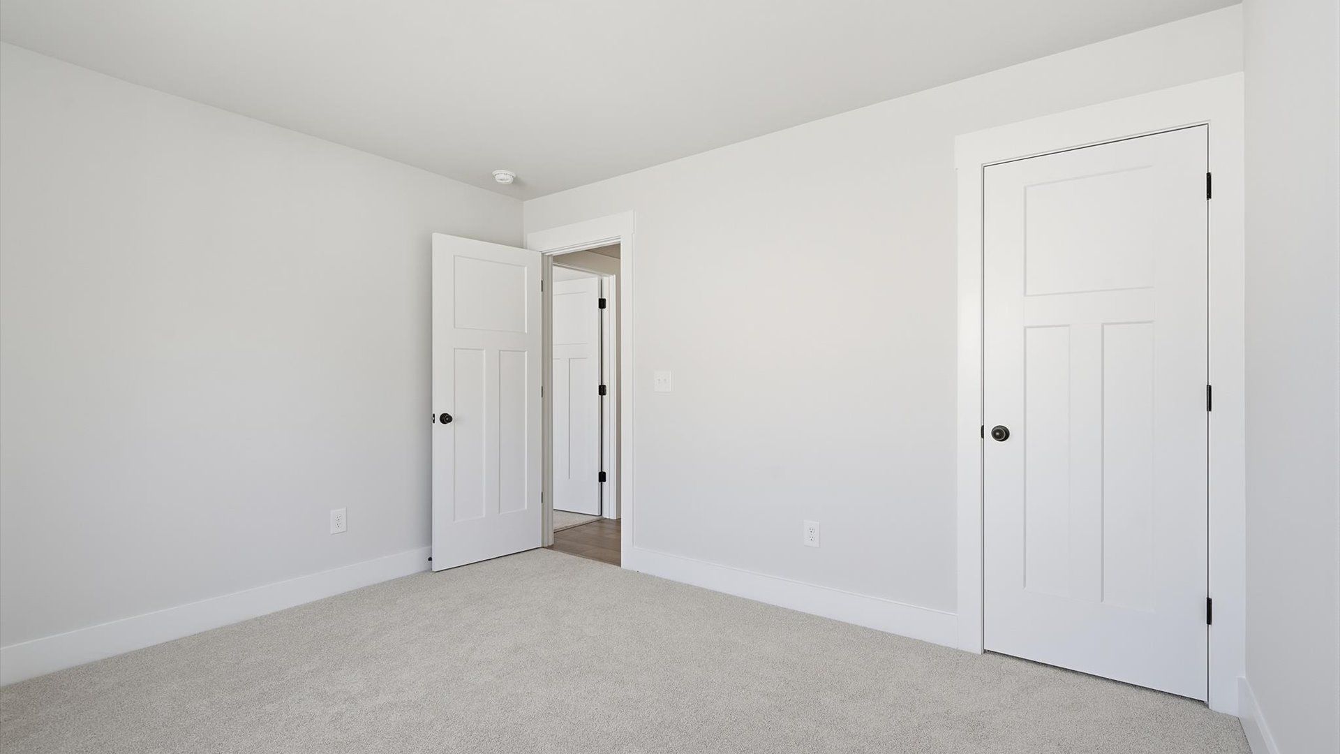 Vibrant and restful bedroom with oversized windows, refined detail, and a warm, welcoming atmosphere