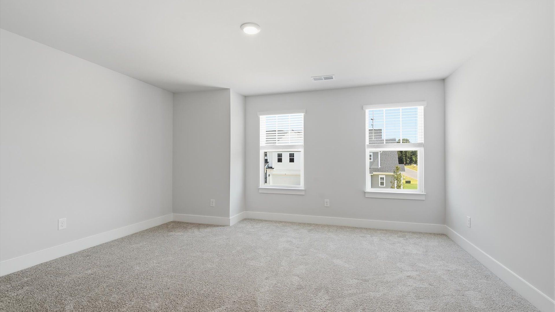 Memorable space with walk-in closet, soft carpeting, and striking natural light from large windows
