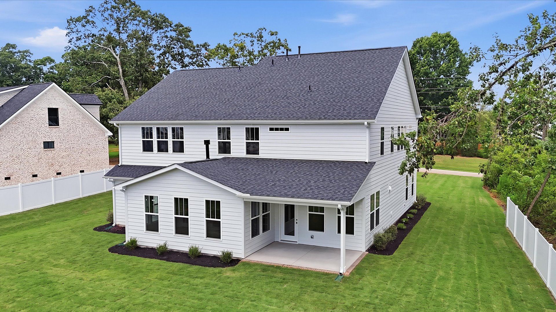 Highly functional rear covered porch adds memorable living space to this elegant home
