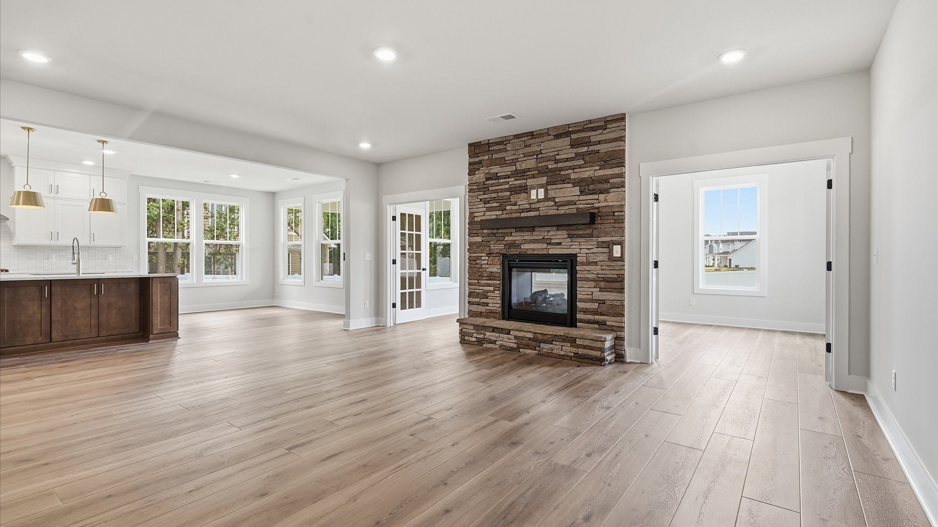 Elegant family room featuring hardwood flooring, large windows, and thoughtful architectural detail in Greenville, SC