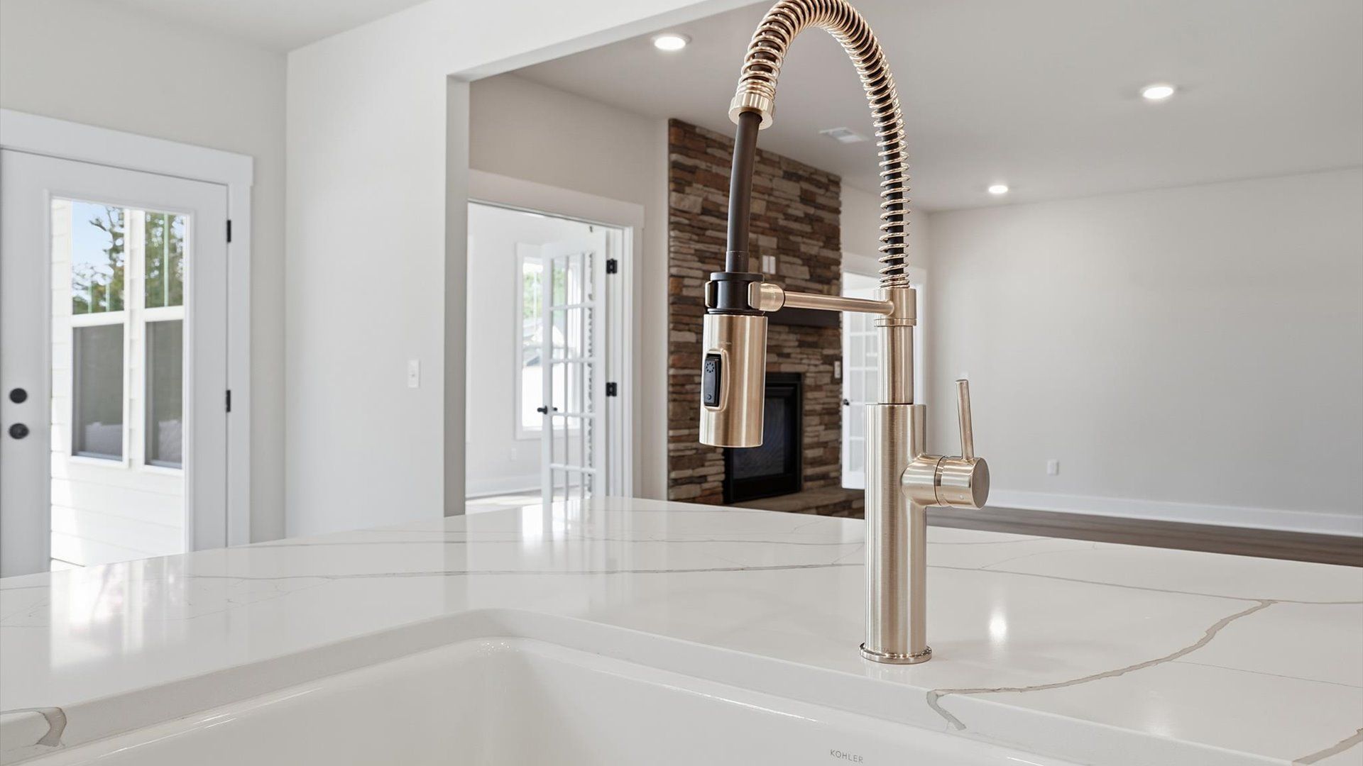 Well-designed kitchen with a center island and tasteful finishes that elevate everyday living by DRB Homes