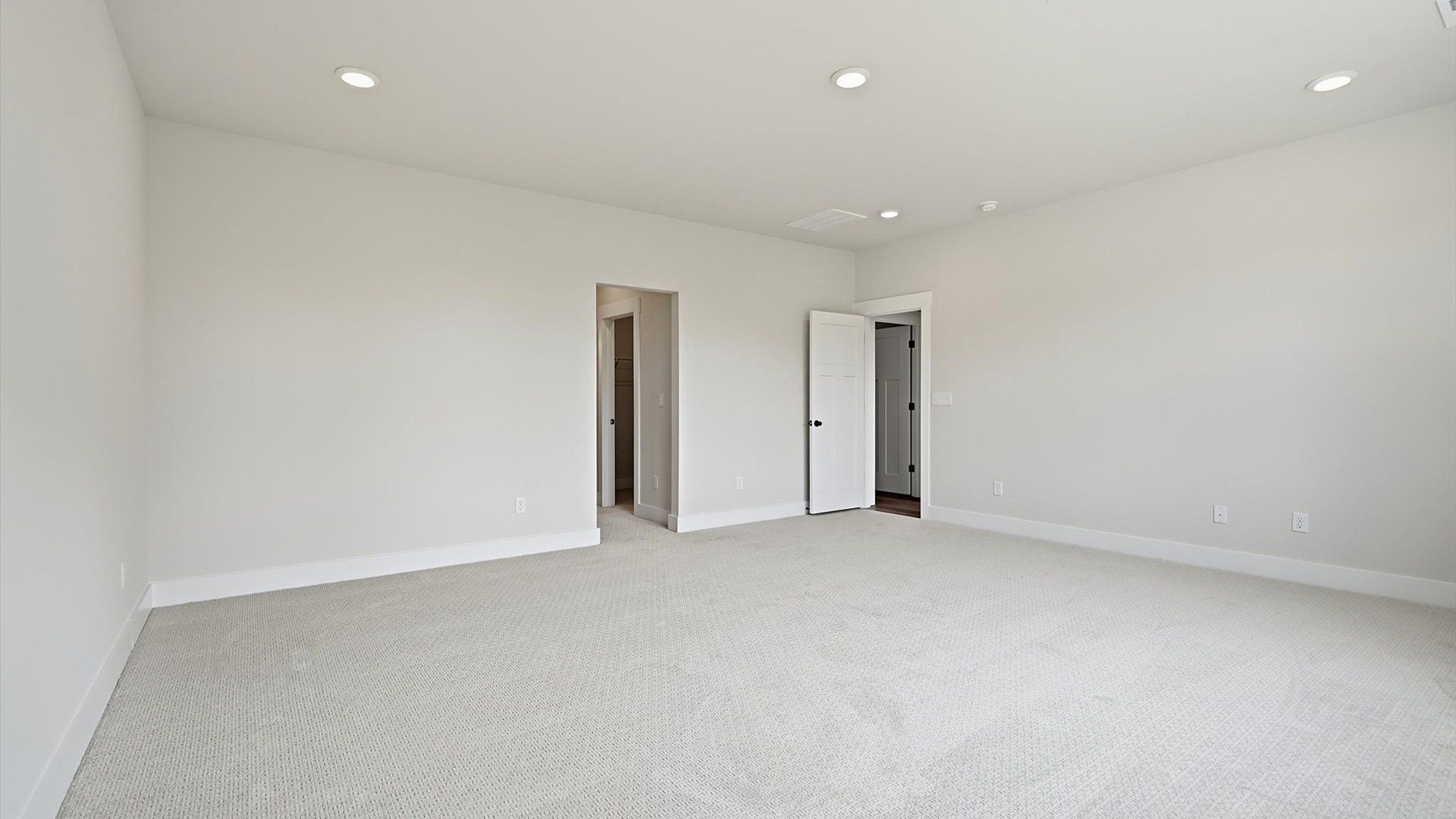 Eye-catching details and elegant finishes in the vibrant primary suite of this select home
