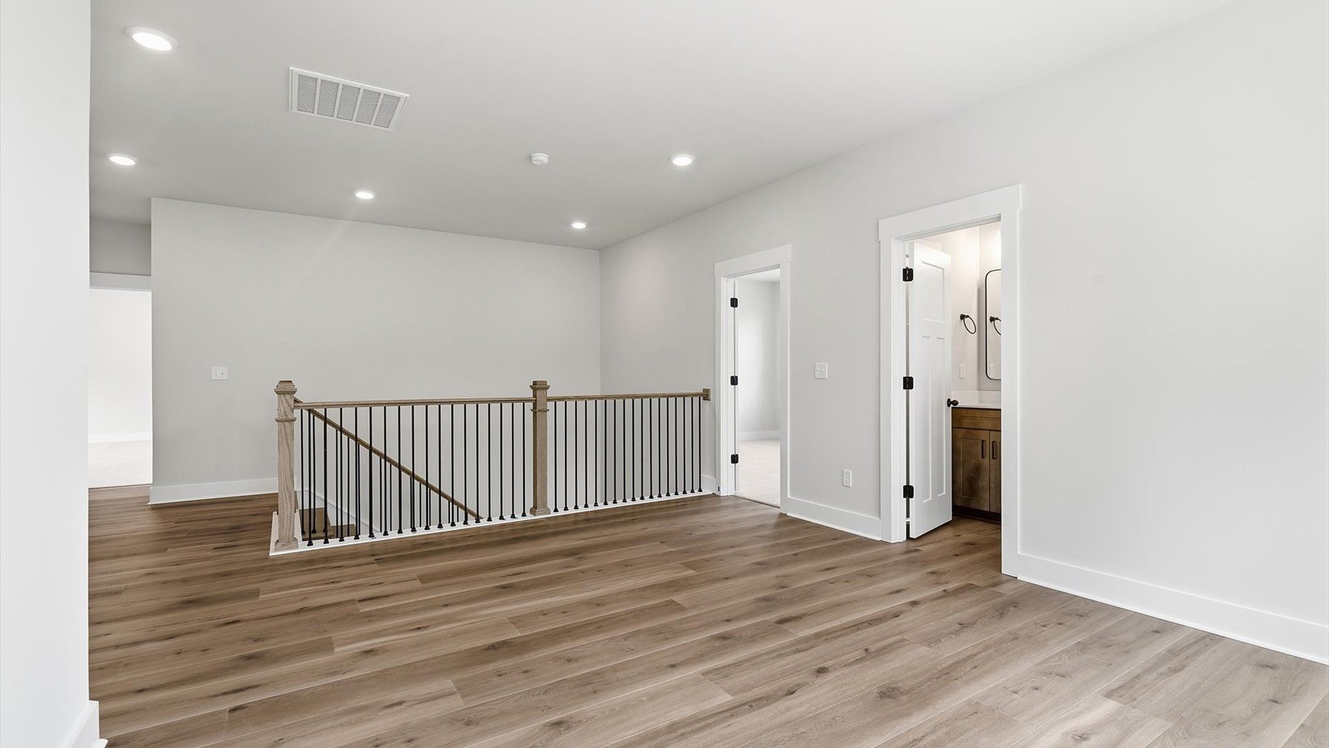 Refined loft featuring hardwood flooring and a thoughtfully designed open-concept layout