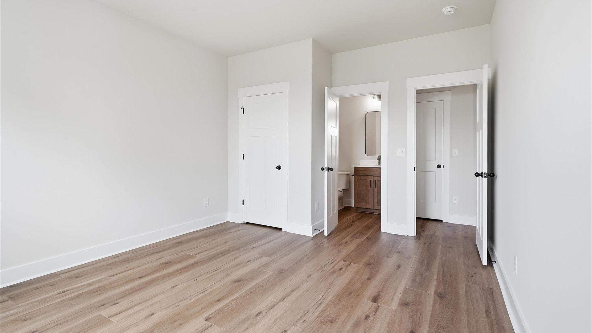Thoughtfully crafted guest suite with durable hardwood flooring