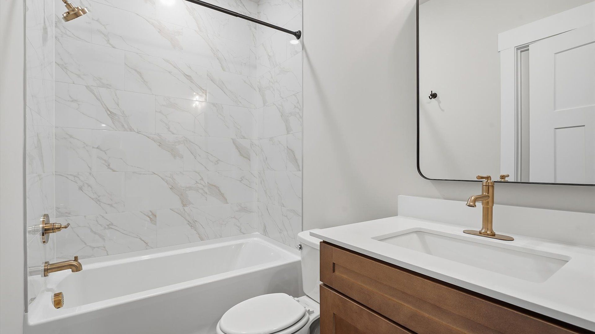 Vibrant and welcoming bathroom with elegant countertop space, tiled shower, and polished details