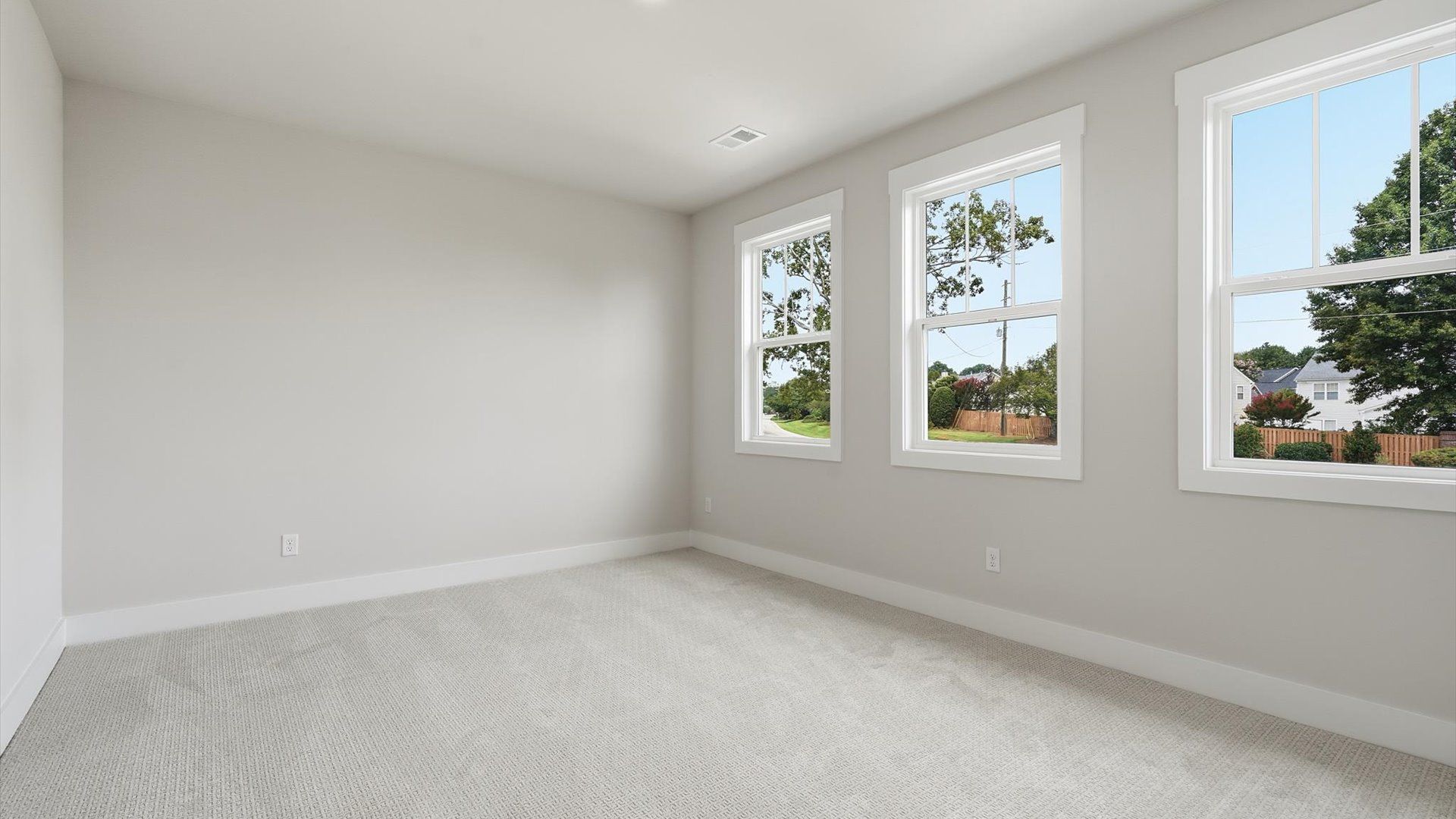 First-rate bedroom with plush carpeting and large windows that provide an open, airy feel
