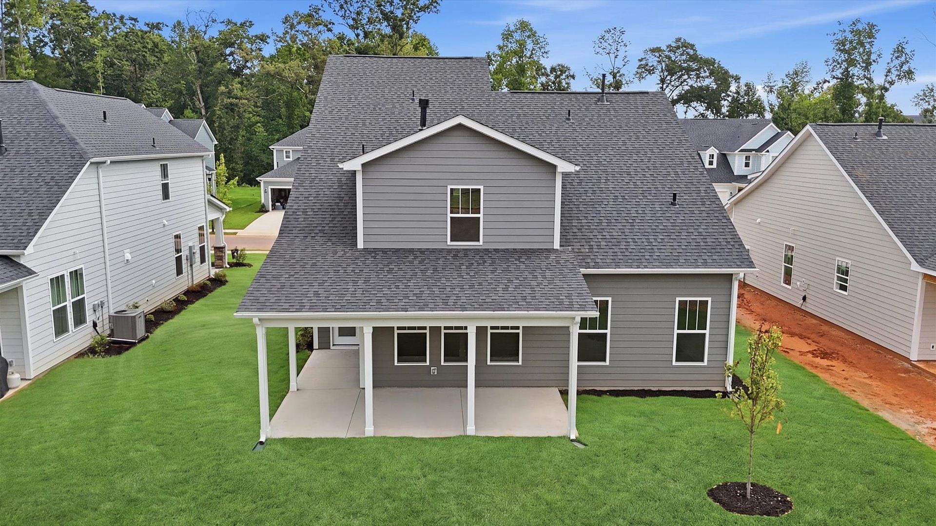 Superior curb appeal continues to the back with a refined, covered outdoor living space