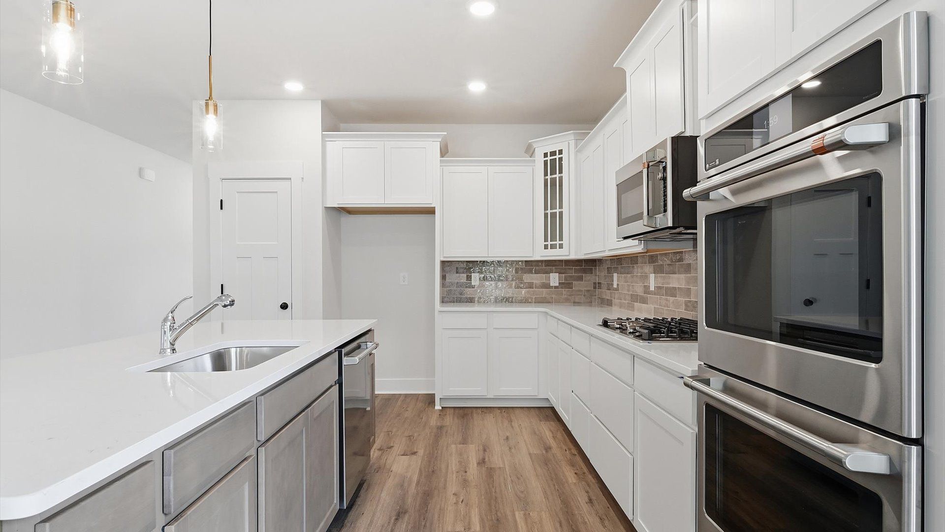 Tasteful kitchen with oversized island and stylish pendant lighting—crafted to high standards in Anderson, SC
