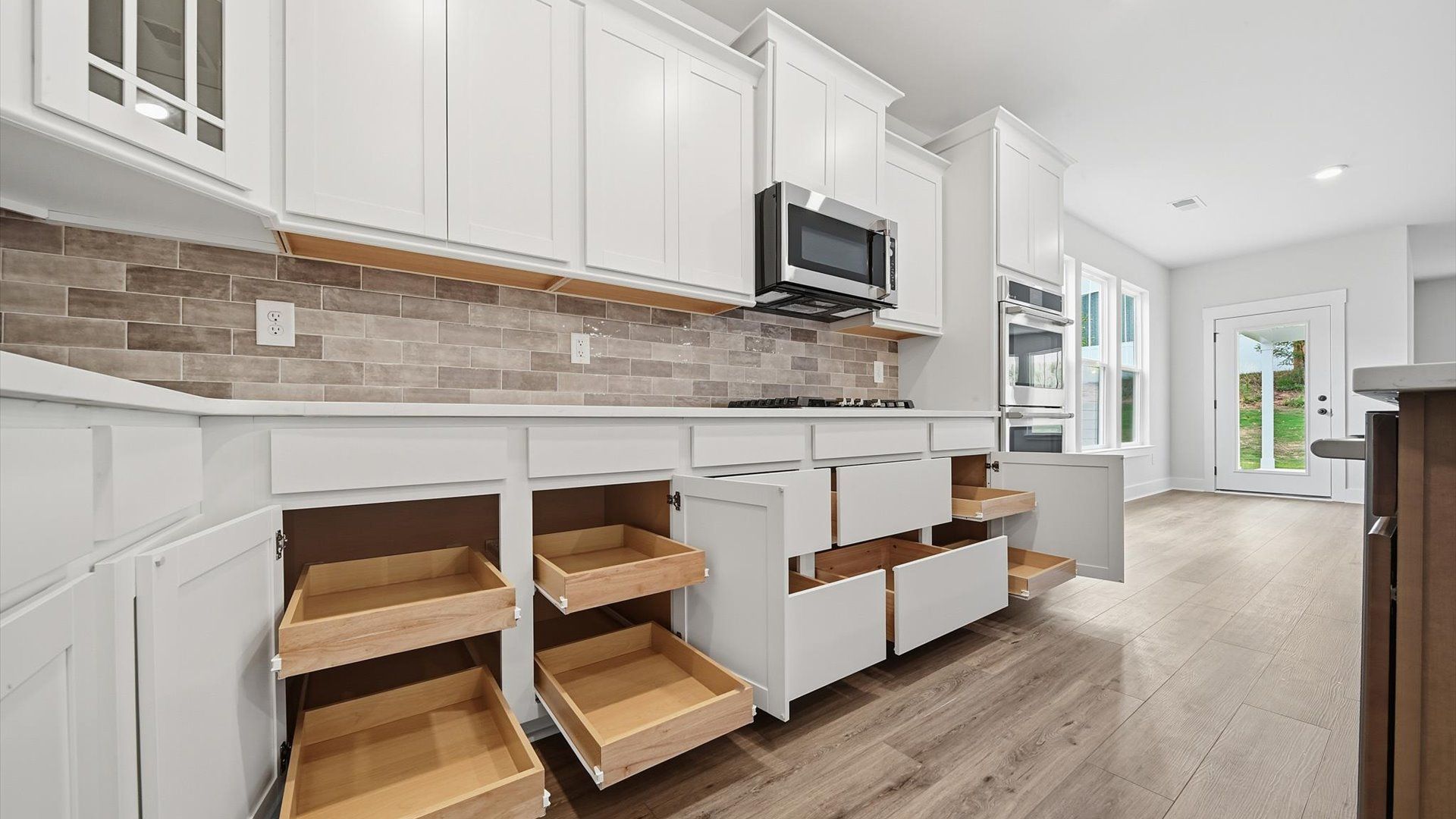 Highly skilled kitchen design includes ample storage, quartz countertops, and stainless steel appliances in Anderson, SC