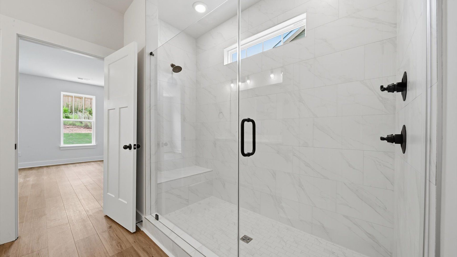 Sophisticated primary bathroom with a spacious walk-in shower and polished hardware