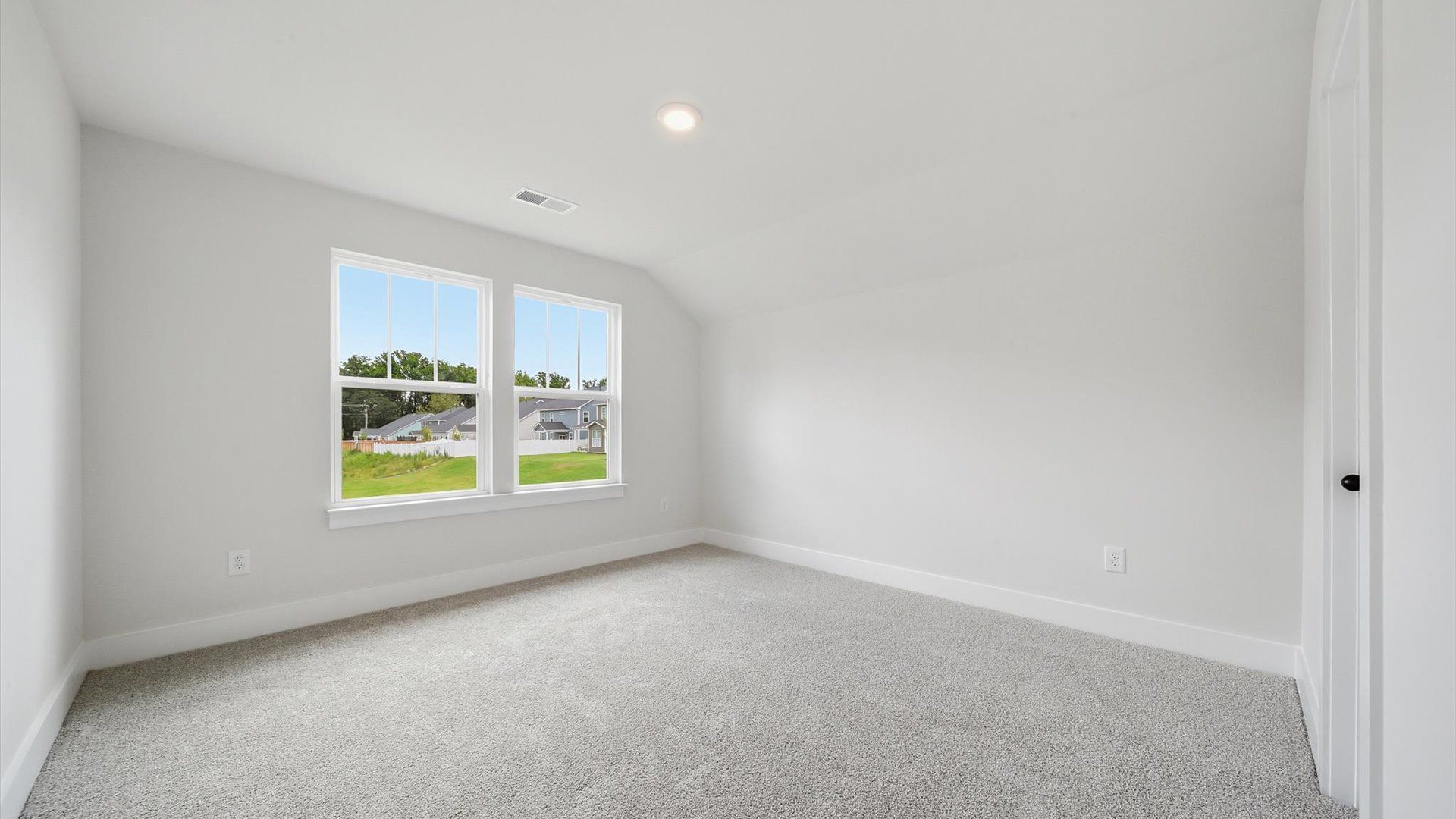 Refined bedroom design with large windows for daylight-filled mornings and peaceful views in Anderson, SC