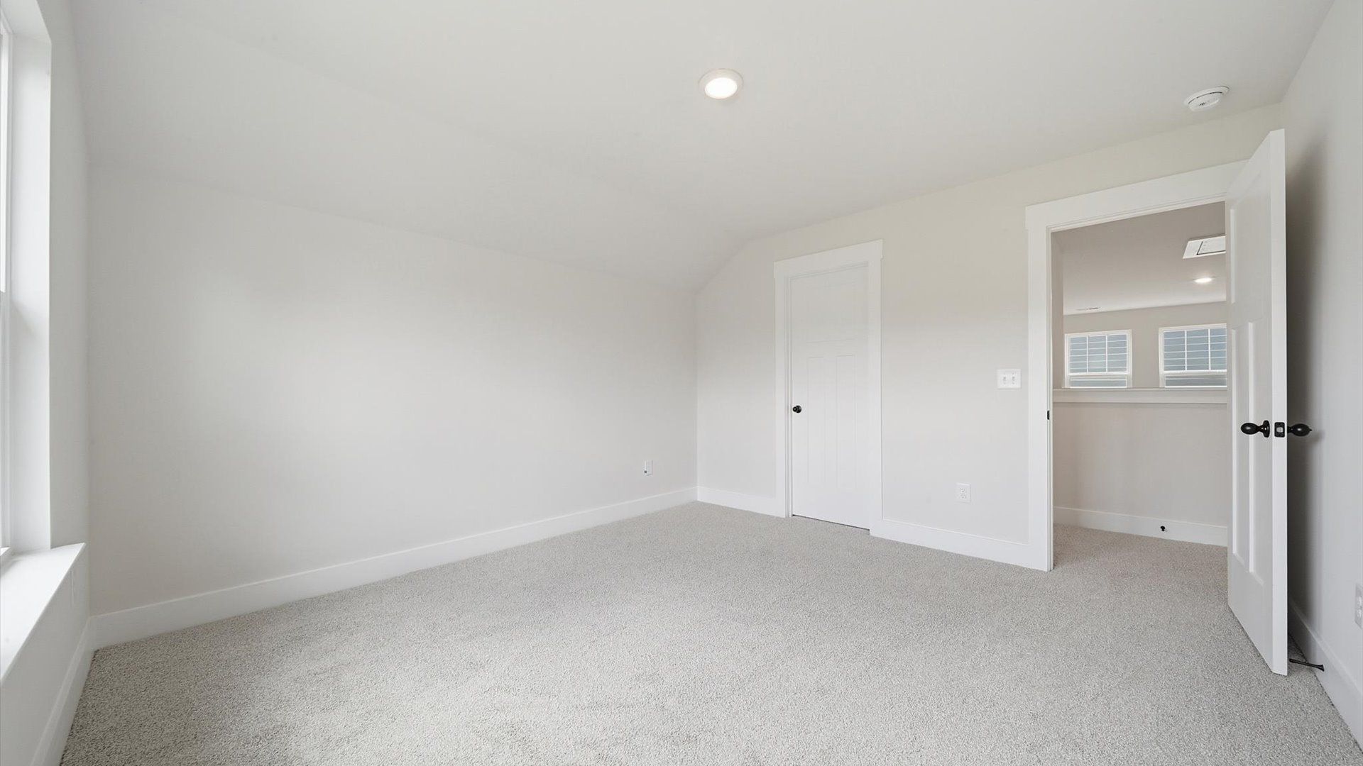 Highly functional bedroom with walk-in closet and tasteful carpet for a restful retreat near Lake Hartwell