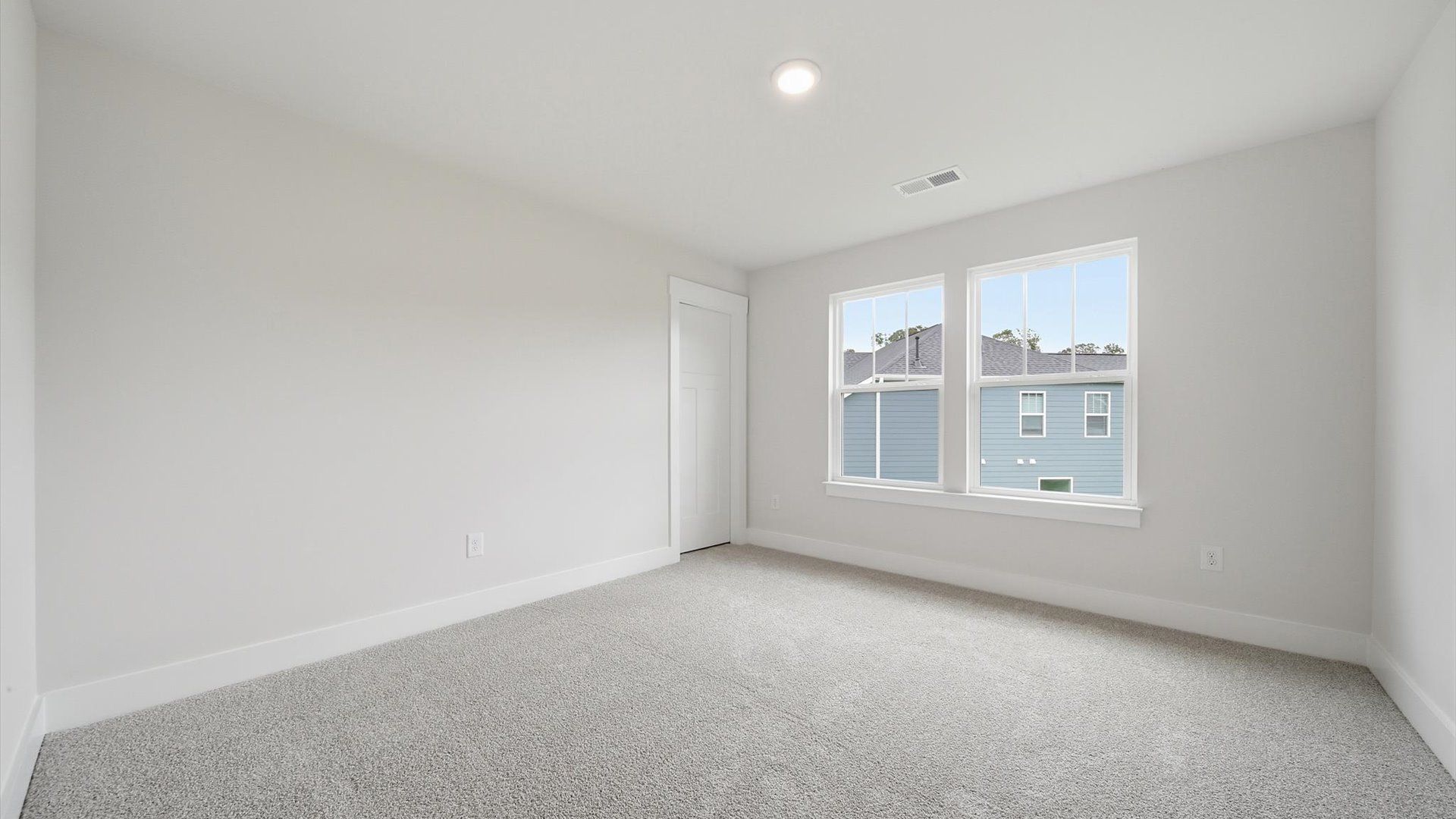 Inviting bedroom with tasteful finishes and large windows that create a fresh, open ambiance by DRB Homes