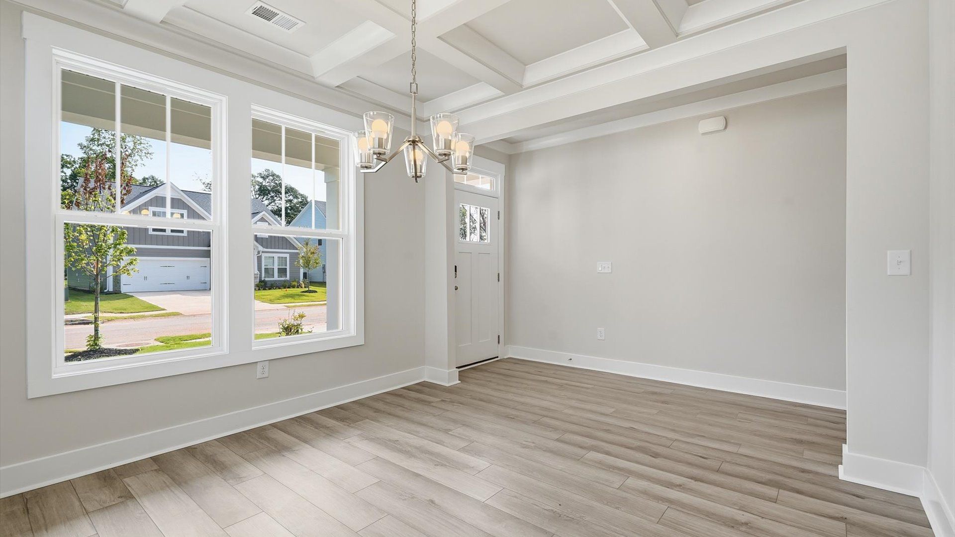 First-class dining area featuring a coffered ceiling and thoughtful architectural detail