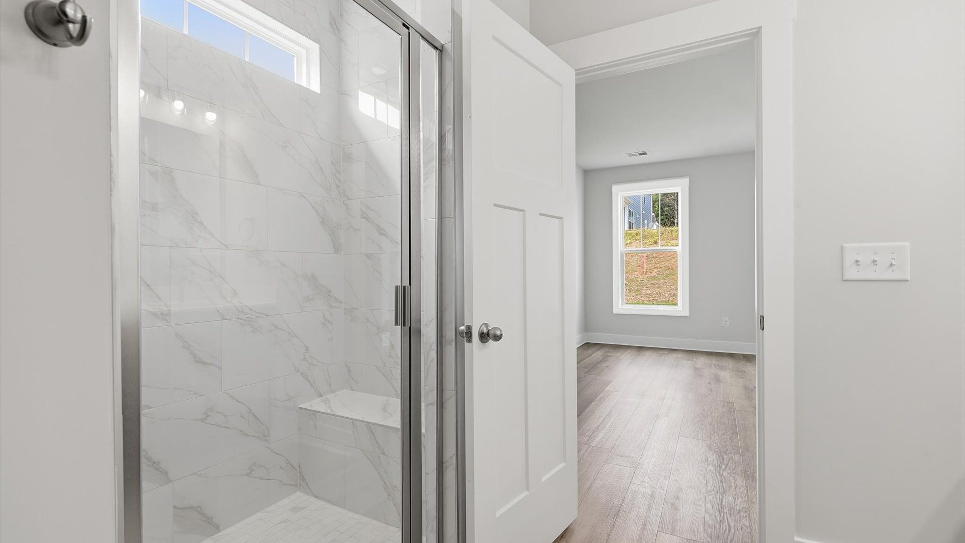 Exceptional en-suite with dual vanity and glass-enclosed tiled walk-in shower for superior everyday comfort