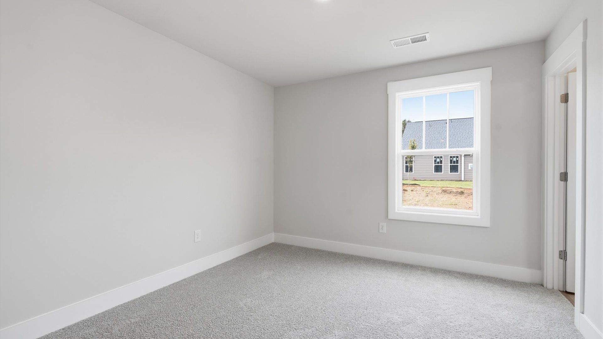 First-class bedroom with generous proportions, a walk-in closet, and beautiful natural light through large windows
