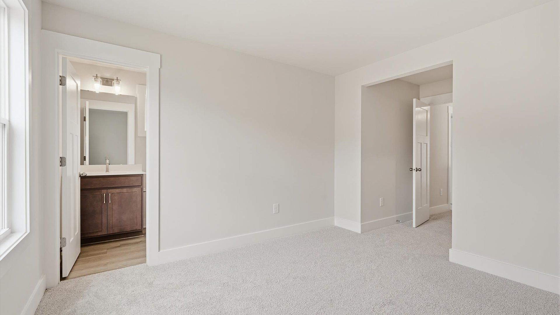 Notable secondary bedroom offering cozy carpeted flooring and a stylish walk-in closet