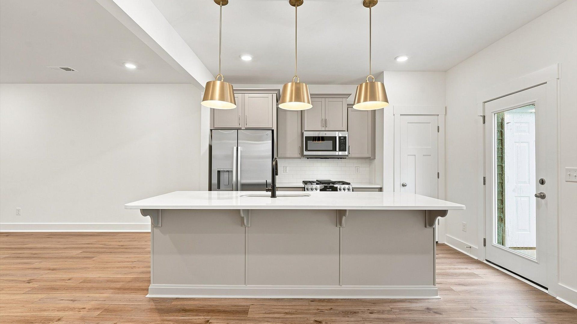 Well-designed kitchen with a center island and tasteful finishes that elevate everyday living by DRB Homes