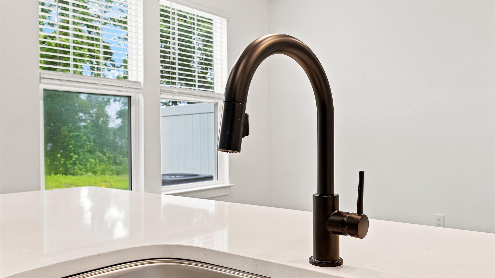 Superior kitchen with quartz countertops, a generously sized island, and abundant natural light