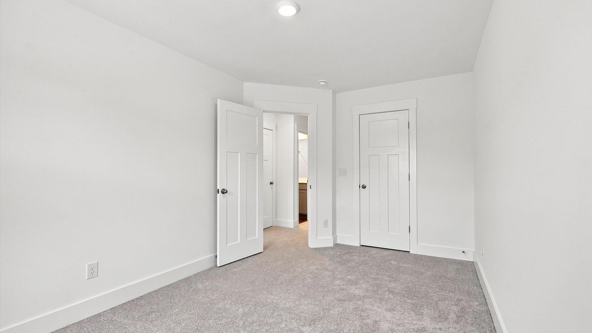 Notable secondary bedroom offering cozy carpeted flooring and a stylish walk-in closet by DRB Homes